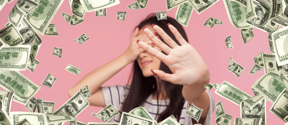 Student covers her eyes with her hand as $100 bills fall around her